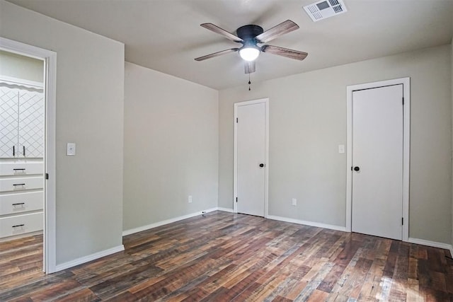 102078 S 3480th Rd, Meeker, OK 74855 - unfurnished bedroom with wood finished floors, ceiling fan, and two closets