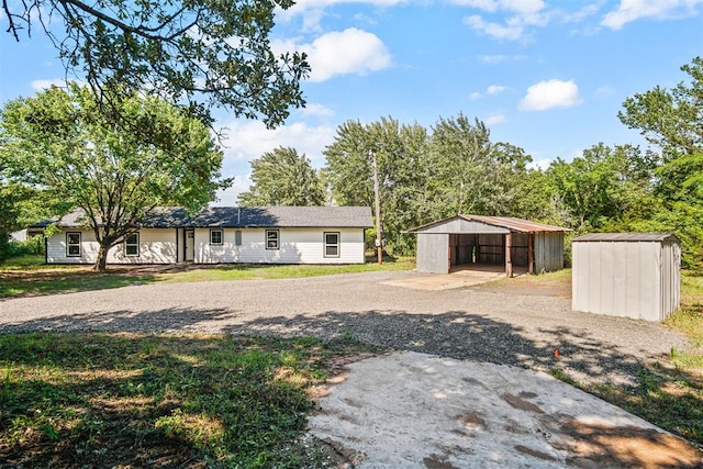 102078 S 3480th Rd, Meeker, OK 74855 - view of front of home featuring a carport, a storage unit, and gravel driveway