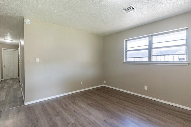 1512 SW 77th Ter, Oklahoma City, OK 73159 - unfurnished room with a textured ceiling, wood finished floors, and a smoke detector