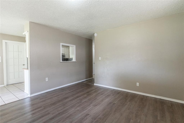 1512 SW 77th Ter, Oklahoma City, OK 73159 - empty room featuring wood finished floors and a textured ceiling