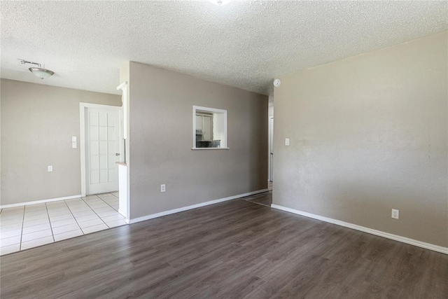 1512 SW 77th Ter, Oklahoma City, OK 73159 - spare room with wood finished floors and a textured ceiling