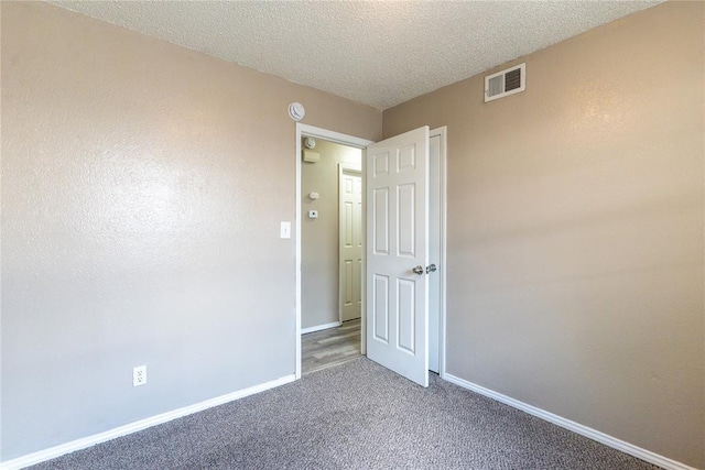 1512 SW 77th Ter, Oklahoma City, OK 73159 - spare room featuring carpet floors and a textured ceiling