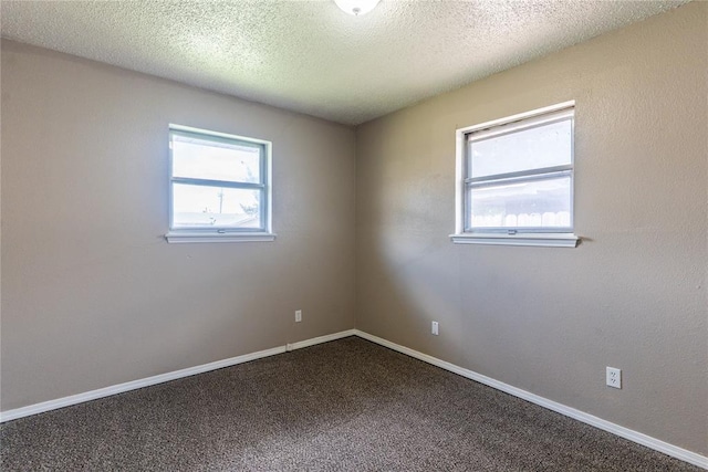 1512 SW 77th Ter, Oklahoma City, OK 73159 - spare room with healthy amount of natural light, dark colored carpet, and a textured ceiling