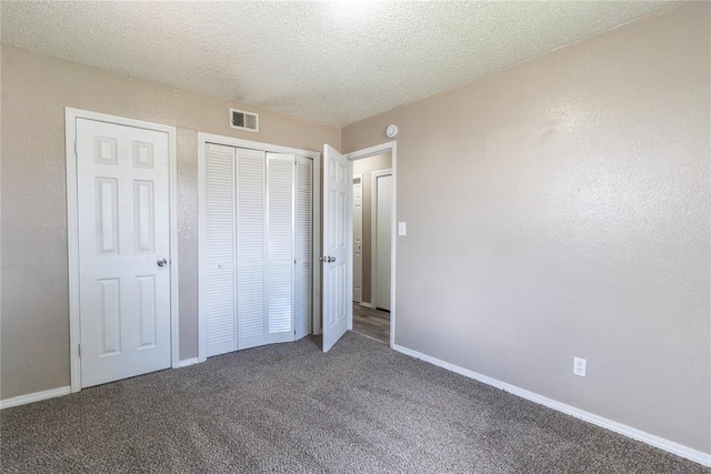 1512 SW 77th Ter, Oklahoma City, OK 73159 - unfurnished bedroom with a closet, carpet floors, and a textured ceiling