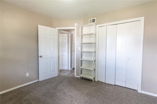 1512 SW 77th Ter, Oklahoma City, OK 73159 - unfurnished bedroom with carpet floors, a closet, and a textured ceiling
