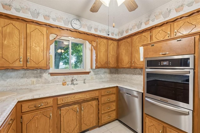 13722 NE 9th St, Choctaw, OK 73020 - kitchen featuring appliances with stainless steel finishes, a warming drawer, light countertops, and brown cabinets
