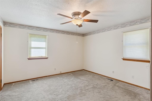13722 NE 9th St, Choctaw, OK 73020 - spare room featuring light carpet, a ceiling fan, and a textured ceiling