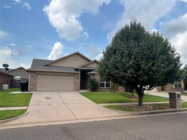 1108 SW 158th St, Oklahoma City, OK 73170 - view of front facade with an attached garage, concrete driveway, a front yard, and brick siding