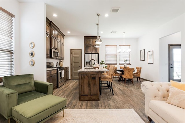 13 Ivory Dr, Yukon, OK 73099 - living room with a chandelier, dark wood-type flooring, and recessed lighting