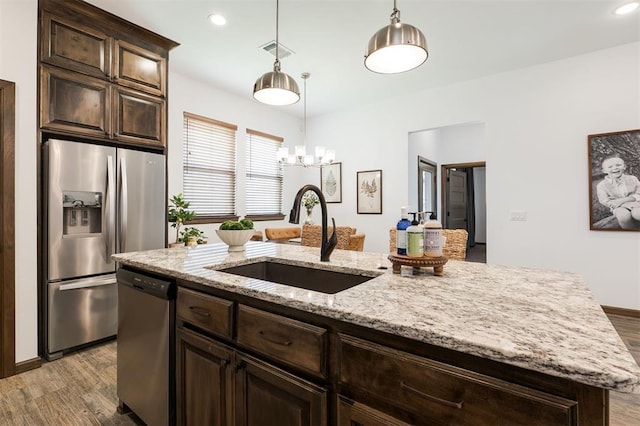13 Ivory Dr, Yukon, OK 73099 - kitchen featuring appliances with stainless steel finishes, wood finished floors, dark brown cabinets, and recessed lighting