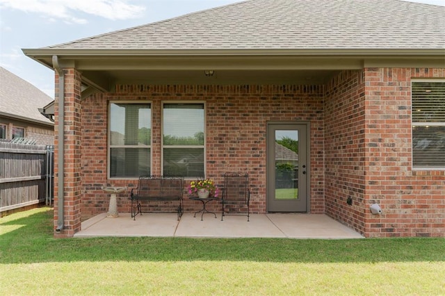 13 Ivory Dr, Yukon, OK 73099 - back of house featuring roof with shingles, brick siding, and a patio area