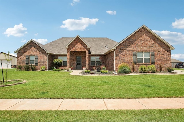 12825 SW 26th St, Yukon, OK 73099 - ranch-style house with brick siding, a front lawn, and roof with shingles