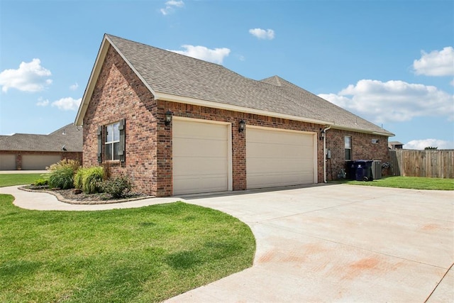 12825 SW 26th St, Yukon, OK 73099 - view of side of home featuring roof with shingles, brick siding, driveway, and a garage