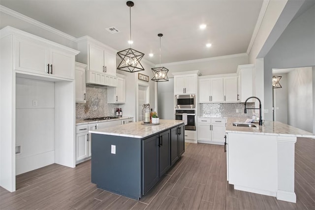 12825 SW 26th St, Yukon, OK 73099 - kitchen with white cabinets, tasteful backsplash, a center island, crown molding, and recessed lighting