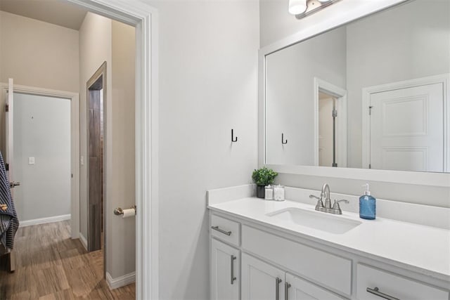 12825 SW 26th St, Yukon, OK 73099 - bathroom with vanity and wood finished floors