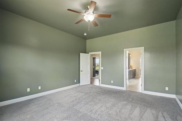 12825 SW 26th St, Yukon, OK 73099 - unfurnished bedroom featuring light colored carpet, connected bathroom, and ceiling fan