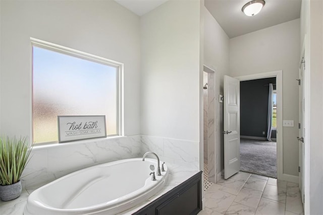 12825 SW 26th St, Yukon, OK 73099 - bathroom featuring marble finish floors and a garden tub