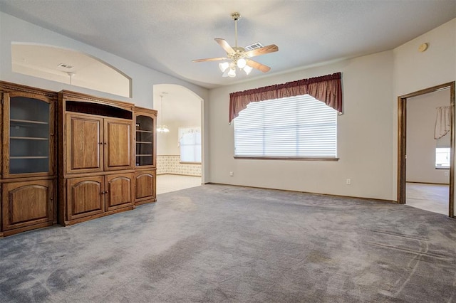 2401 Westchester Dr, Moore, OK 73160 - unfurnished living room with carpet flooring, a ceiling fan, and arched walkways