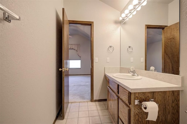 2401 Westchester Dr, Moore, OK 73160 - bathroom featuring vaulted ceiling, vanity, tile patterned flooring, and a textured wall