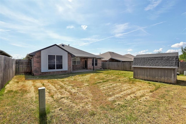 2401 Westchester Dr, Moore, OK 73160 - rear view of house featuring a shed, brick siding, a fenced backyard, and a patio