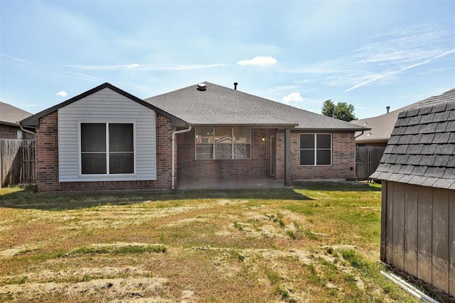 2401 Westchester Dr, Moore, OK 73160 - rear view of property with roof with shingles, a patio area, and brick siding