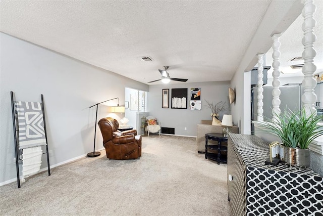 815 W 7th St, Edmond, OK 73003 - living area featuring carpet floors, a ceiling fan, and a textured ceiling