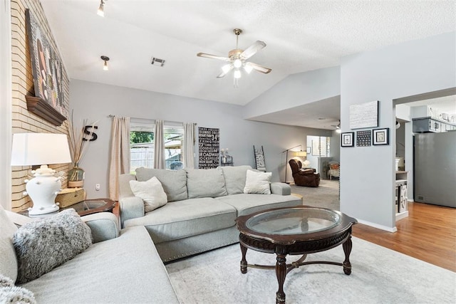 815 W 7th St, Edmond, OK 73003 - living room with a ceiling fan, lofted ceiling, and wood finished floors