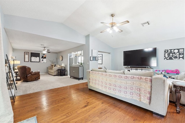 815 W 7th St, Edmond, OK 73003 - living area featuring a ceiling fan, vaulted ceiling, and wood finished floors