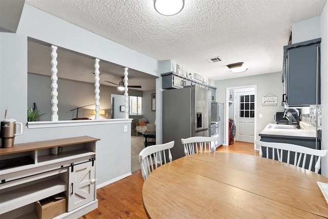 815 W 7th St, Edmond, OK 73003 - dining room with a textured ceiling, wood finished floors, and a ceiling fan