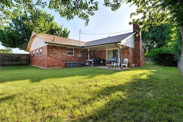 815 W 7th St, Edmond, OK 73003 - back of property featuring brick siding, a chimney, and a fenced backyard