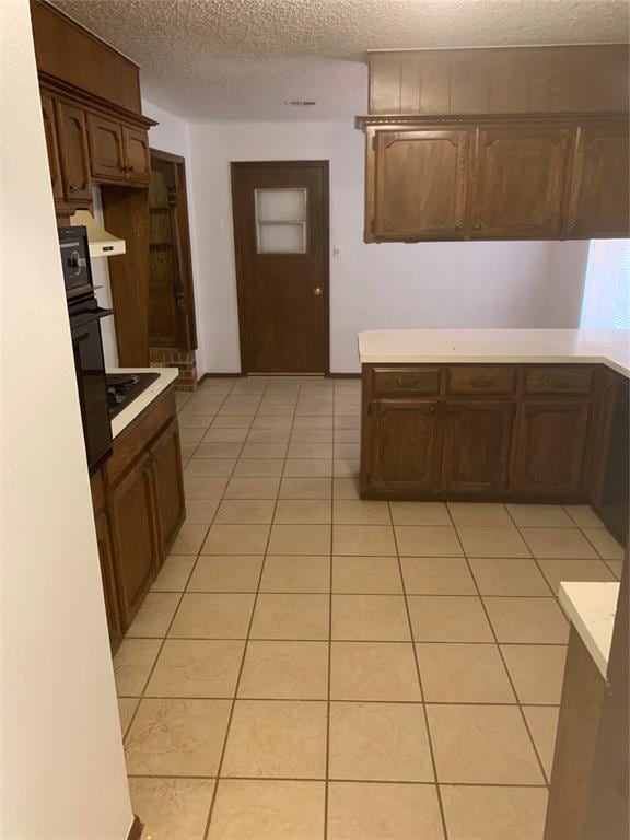 515 Cripple Creek Dr, Norman, OK 73071 - kitchen with light countertops, a textured ceiling, light tile patterned floors, and oven