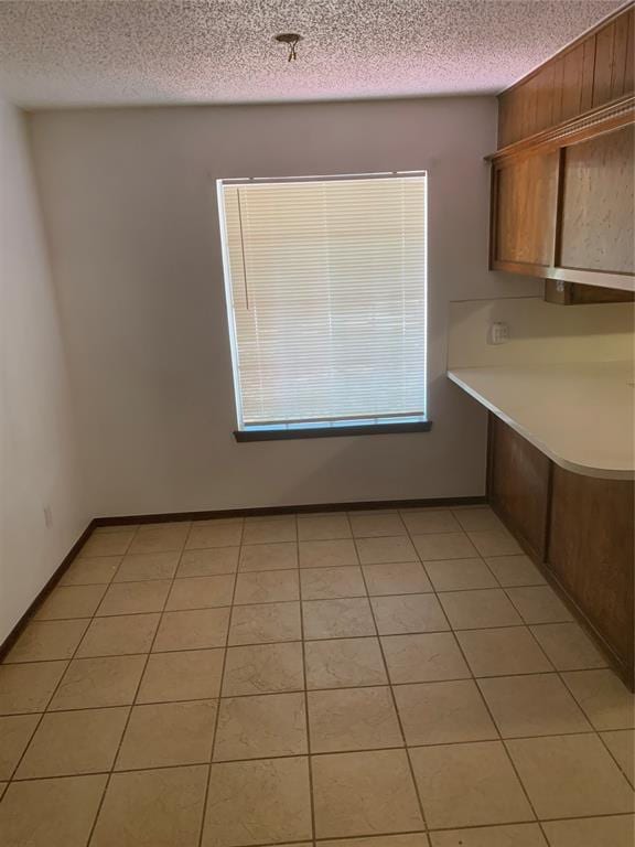 515 Cripple Creek Dr, Norman, OK 73071 - unfurnished dining area featuring a textured ceiling