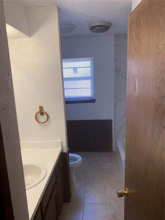 515 Cripple Creek Dr, Norman, OK 73071 - bathroom with vanity, a textured ceiling, and bathing tub / shower combination