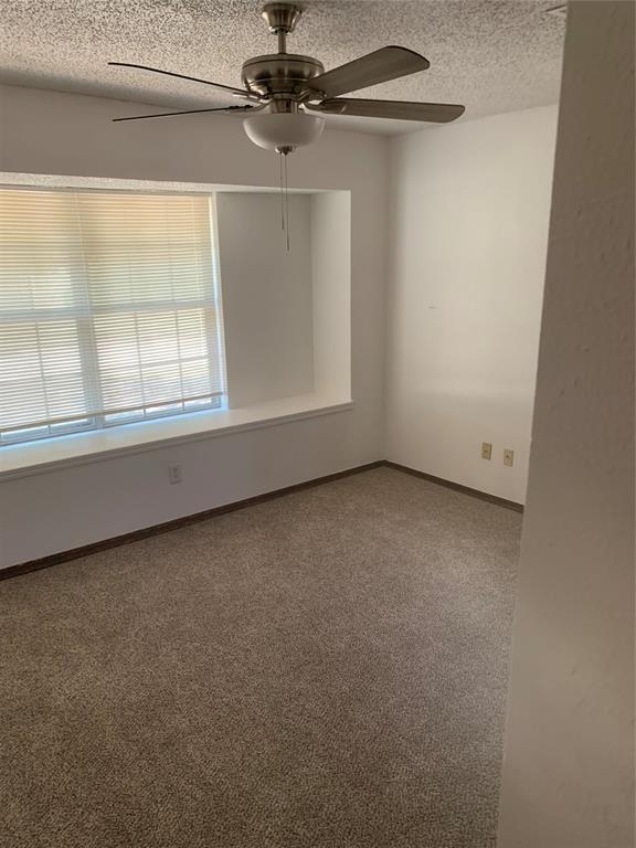 515 Cripple Creek Dr, Norman, OK 73071 - carpeted spare room with ceiling fan and a textured ceiling