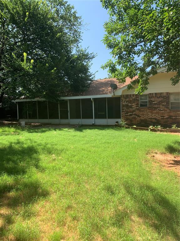 515 Cripple Creek Dr, Norman, OK 73071 - view of grassy yard with a sunroom