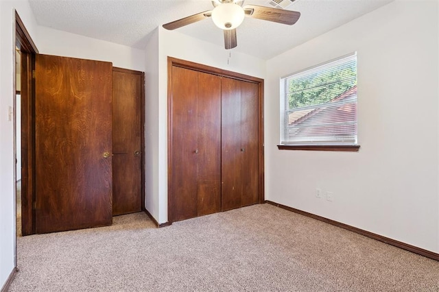 515 Cripple Creek Dr, Norman, OK 73071 - unfurnished bedroom with light carpet, a closet, and a ceiling fan