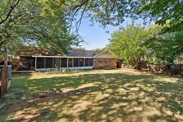 515 Cripple Creek Dr, Norman, OK 73071 - back of house featuring a sunroom, a fenced backyard, and brick siding