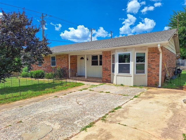 2901 Maple Ln, Edmond, OK 73034 - ranch-style home with brick siding, a porch, and a shingled roof