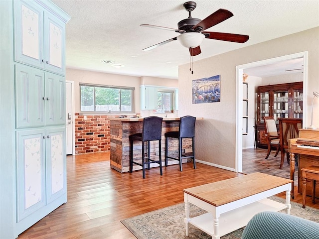 2901 Maple Ln, Edmond, OK 73034 - living room with light wood-style flooring, ceiling fan, and a textured ceiling