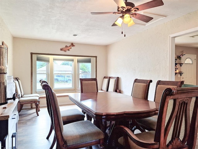 2901 Maple Ln, Edmond, OK 73034 - dining area featuring a textured wall, a textured ceiling, a ceiling fan, and wood finished floors