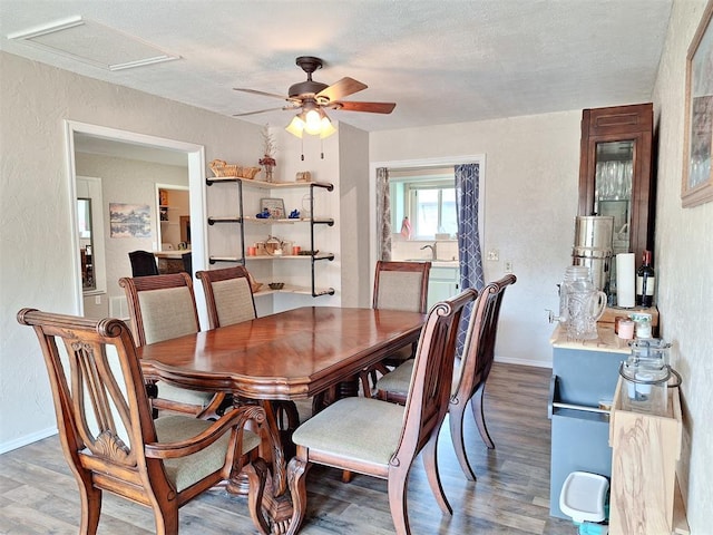 2901 Maple Ln, Edmond, OK 73034 - dining room with ceiling fan, wood finished floors, a textured wall, and a textured ceiling