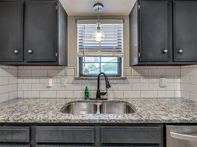 6500 N Grand Blvd Unit 131, Oklahoma City, OK 73116 - kitchen featuring dishwasher, a textured ceiling, decorative backsplash, pendant lighting, and light stone counters