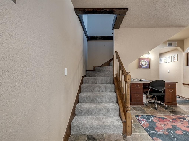 6500 N Grand Blvd Unit 131, Oklahoma City, OK 73116 - stairs with a textured wall and stone finish floors