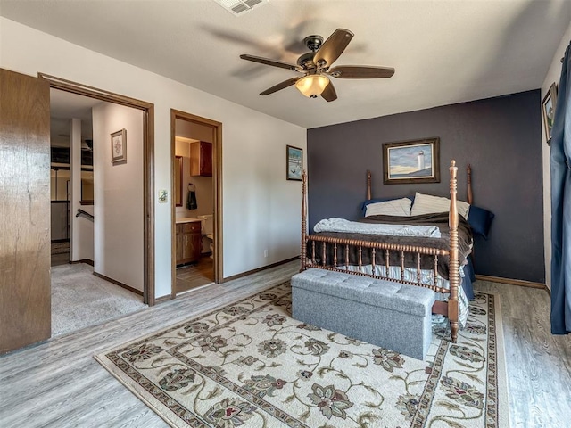 6500 N Grand Blvd Unit 131, Oklahoma City, OK 73116 - bedroom featuring wood finished floors, ceiling fan, and ensuite bath