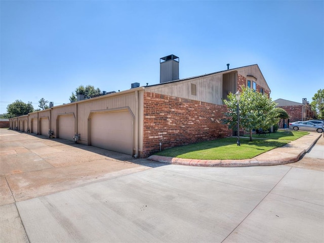 6500 N Grand Blvd Unit 131, Oklahoma City, OK 73116 - view of side of property with brick siding, a lawn, and a chimney