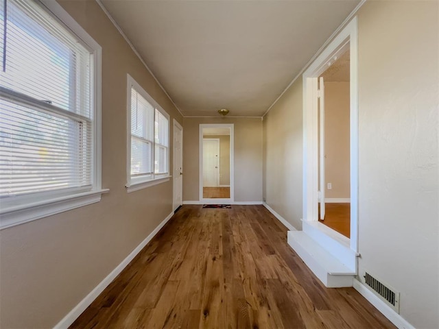2437 NW 36th Ter, Oklahoma City, OK 73112 - hallway with wood finished floors and ornamental molding