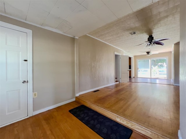 2437 NW 36th Ter, Oklahoma City, OK 73112 - empty room with wood finished floors, ceiling fan, and crown molding