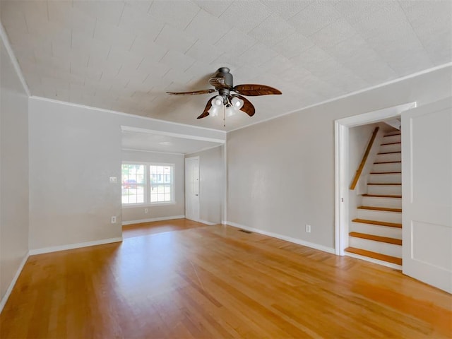 2437 NW 36th Ter, Oklahoma City, OK 73112 - unfurnished room featuring ceiling fan, light wood-type flooring, stairway, and crown molding