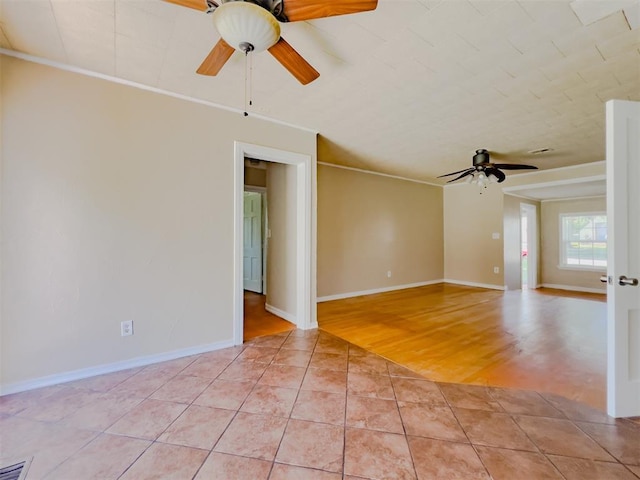 2437 NW 36th Ter, Oklahoma City, OK 73112 - spare room with a ceiling fan, ornamental molding, and light tile patterned floors