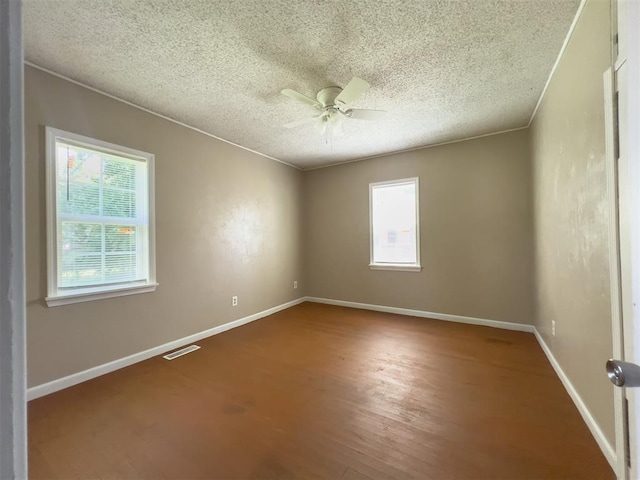 2437 NW 36th Ter, Oklahoma City, OK 73112 - empty room with ceiling fan, a textured ceiling, and wood finished floors